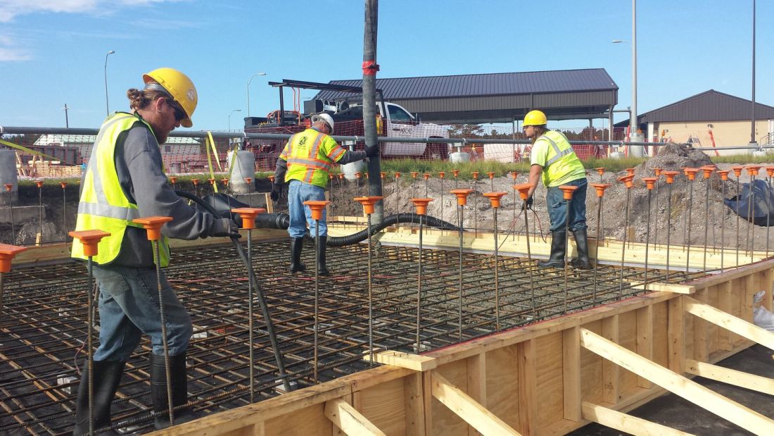 Placing concrete over a reinforced deck between formwork